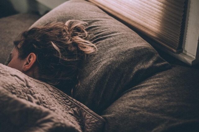 a woman getting a good night’s sleep due to the calming effects of barley tea