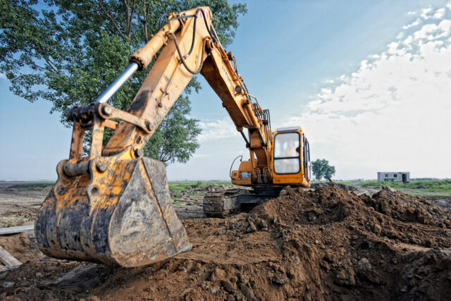 excavator digs a hole