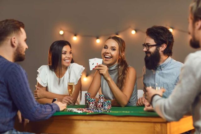 Happy-woman-showing-two-aces-while-playing-poker